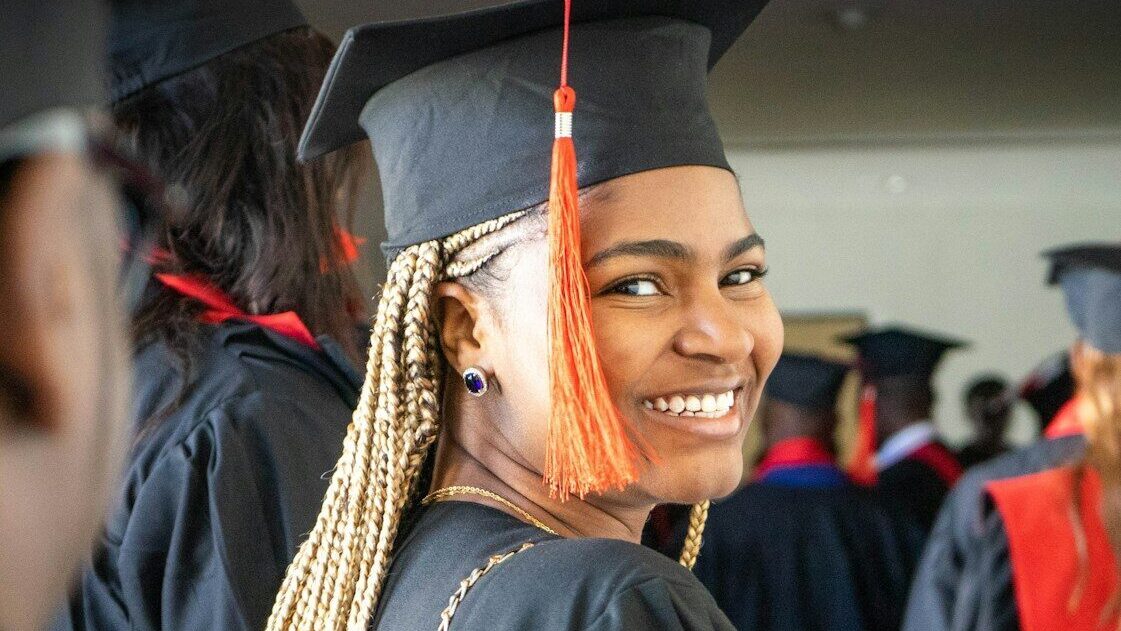 a woman in a graduation cap and gown